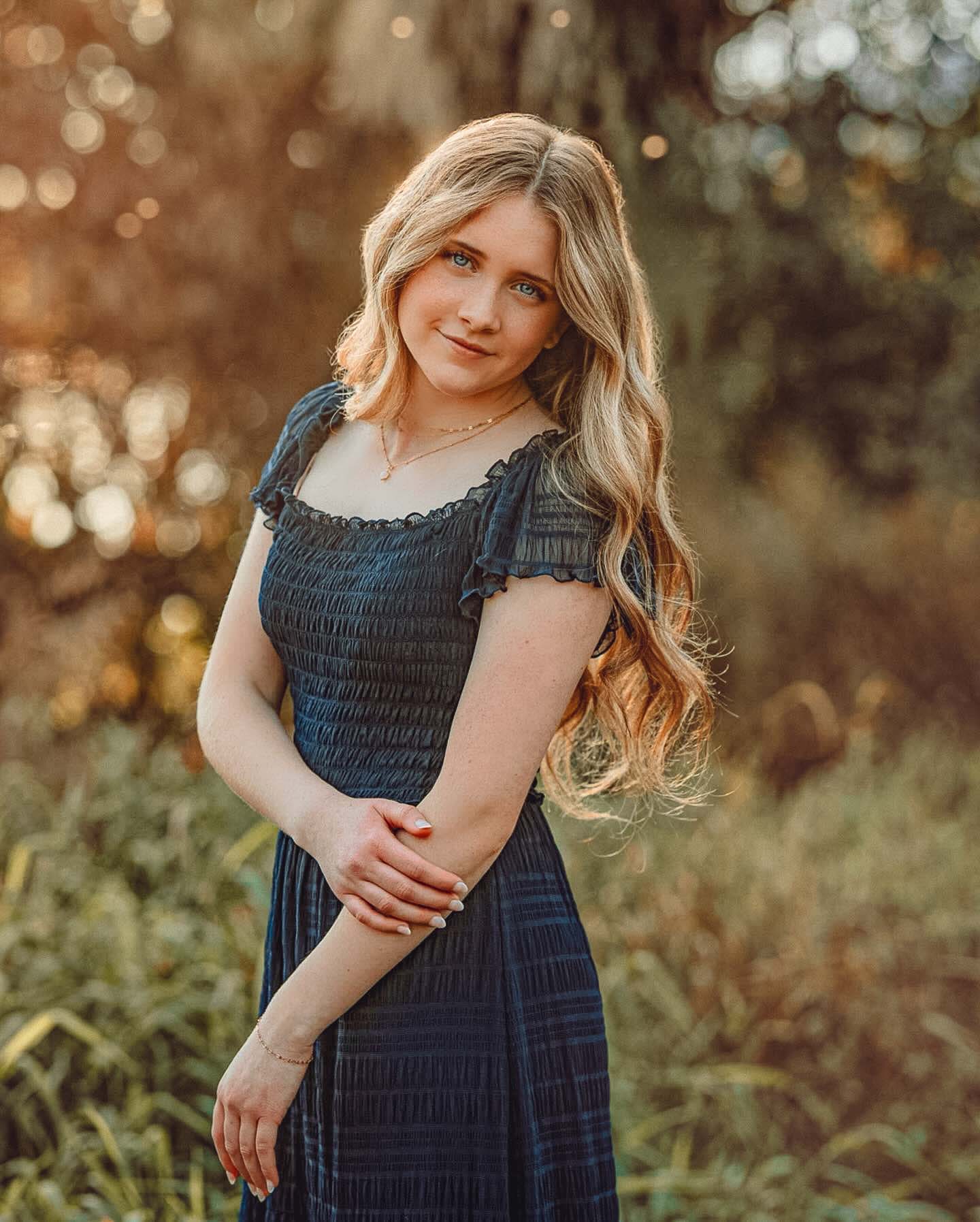 High school senior in a black dress photographed at golden hour in Richland