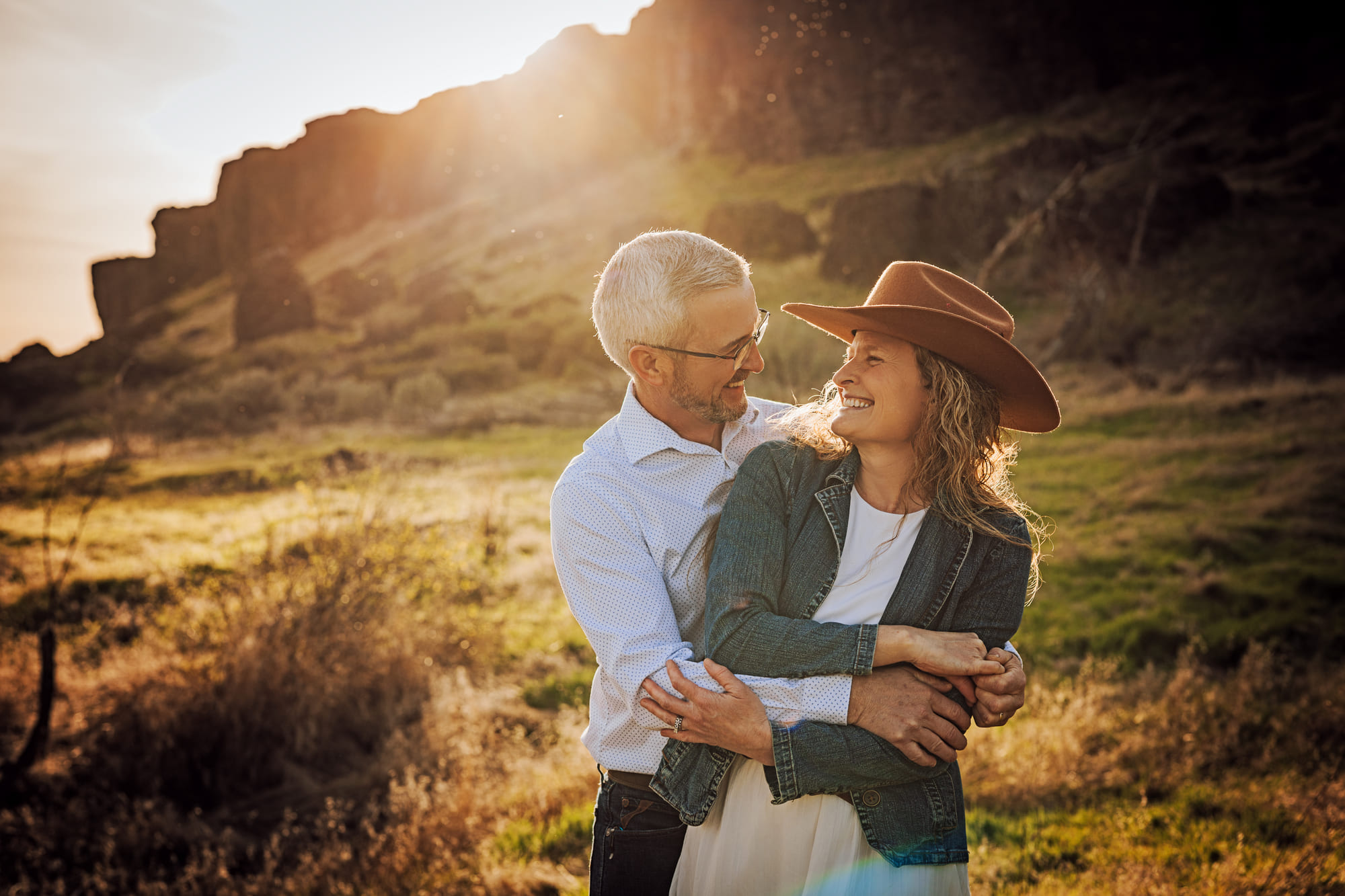 A couple laughing together in warm Columbia Basin evening light