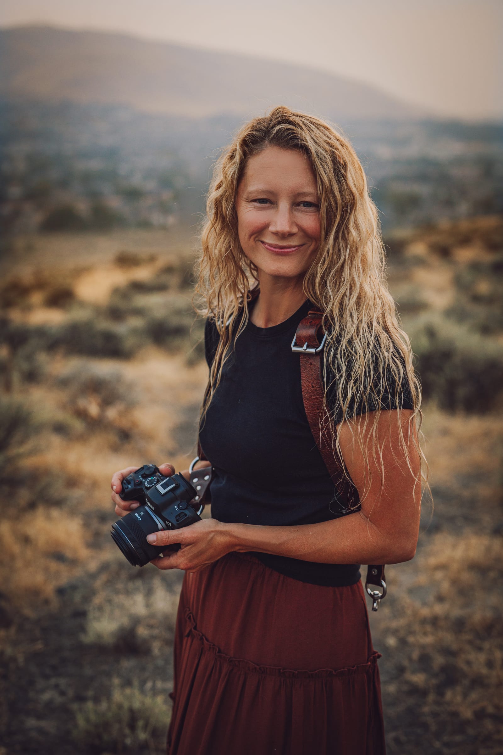 Lisa, owner of It’s A Keeper Photography, holding her camera in the Tri-Cities