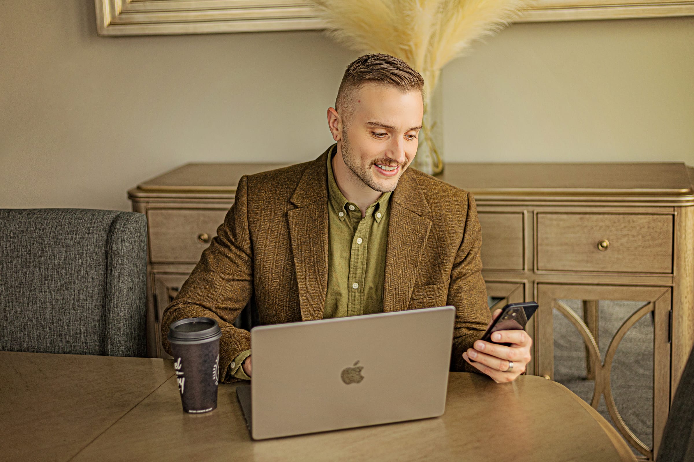 Business man on his phone with laptop and coffee in Richland Tricots, WA