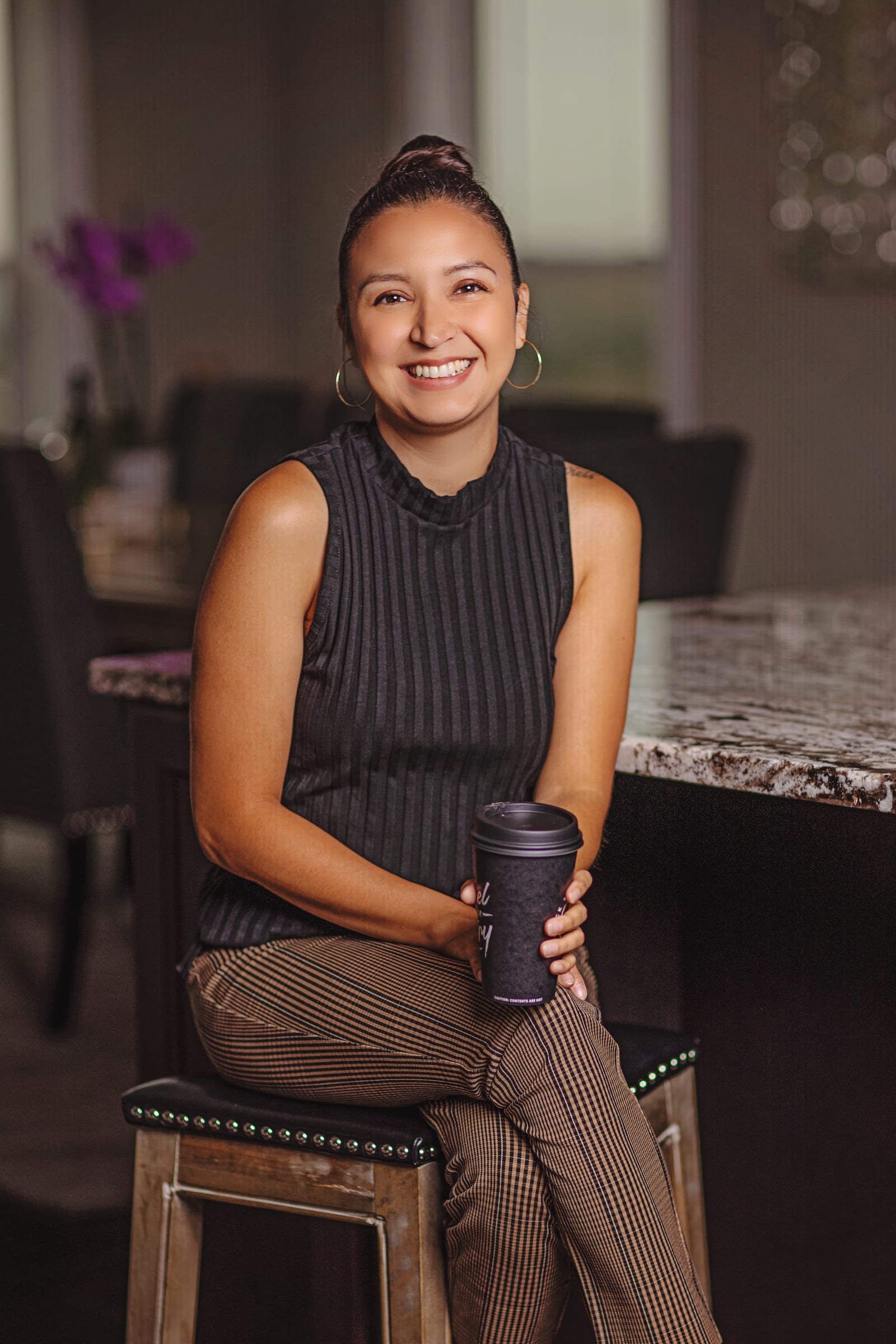 Business professional holding a coffee cup during a relaxed Richland branding portrait.