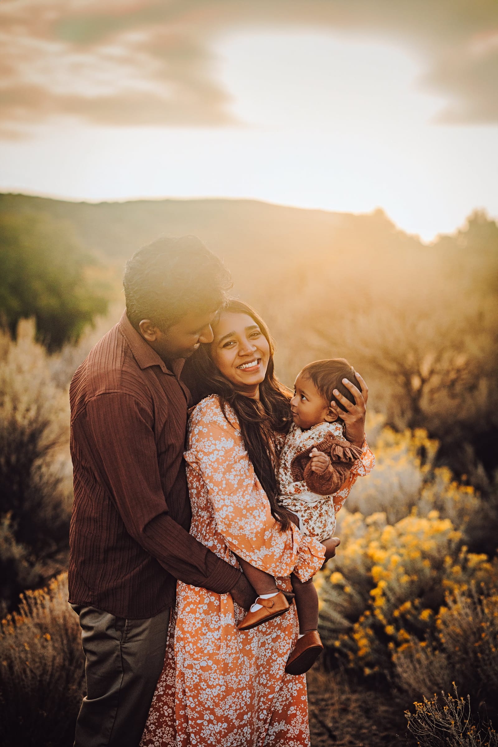 Parents holding their baby during a golden-hour family session