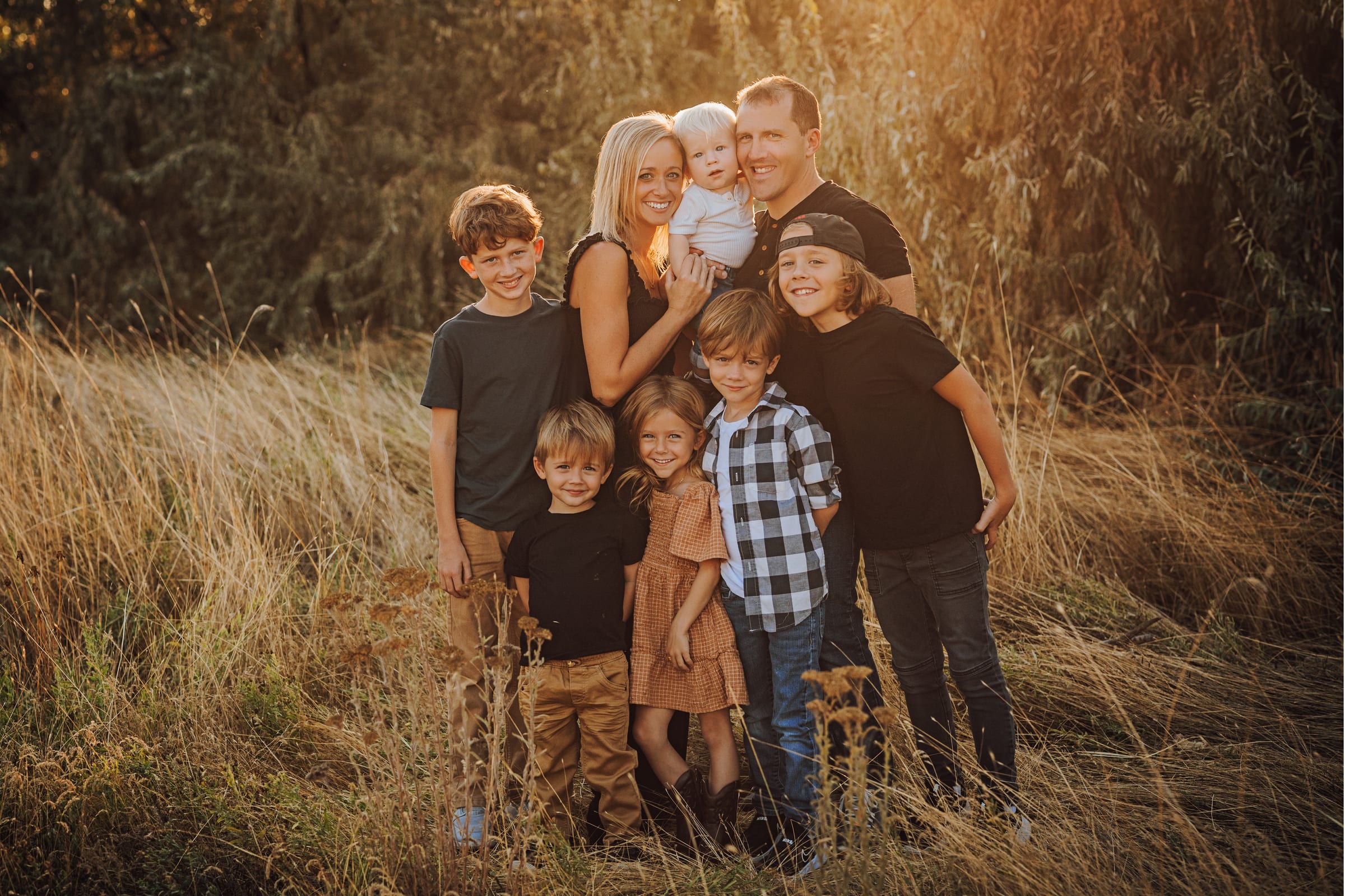 Family gathered together in a golden field.