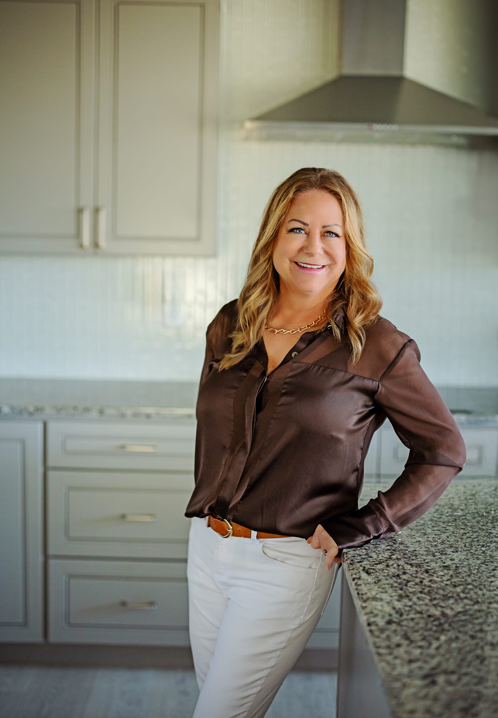 Business owner standing beside a kitchen island during a West Richland branding session.